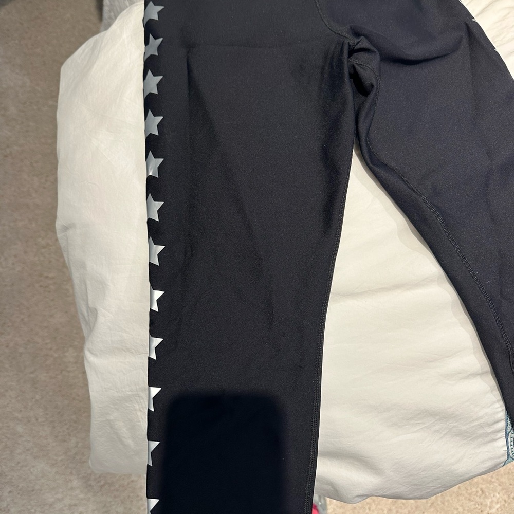Ultracor leggings with silver foil star down side. Small